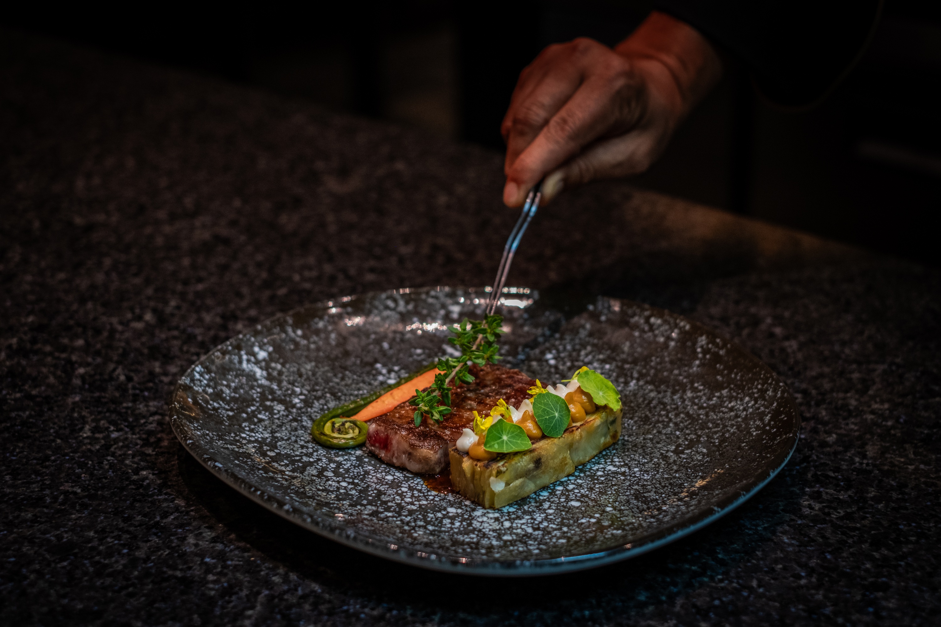 Chef plating a dish at Pemako Punakha