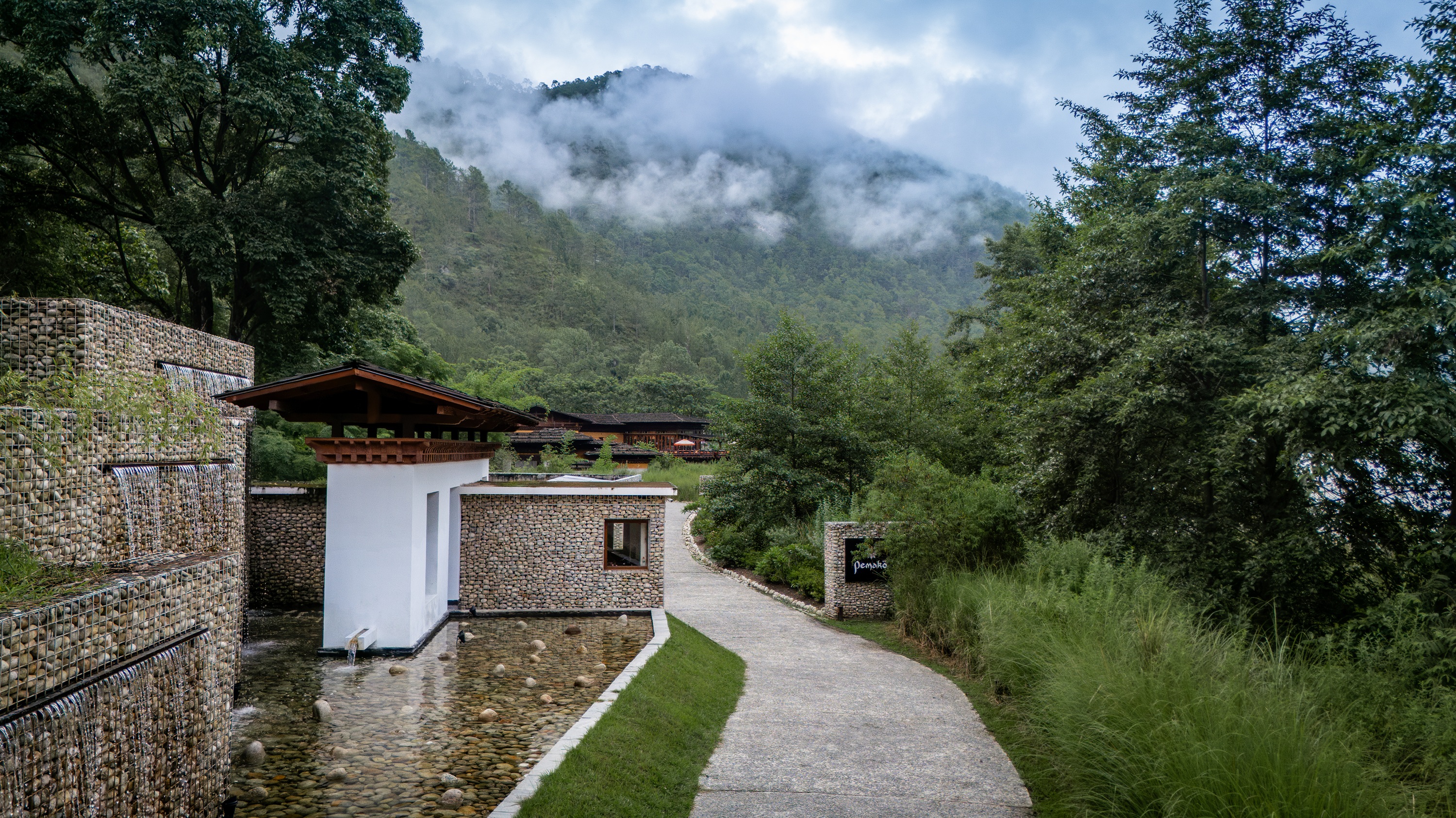 Stone entrance with mountain views at Pemako Punakha