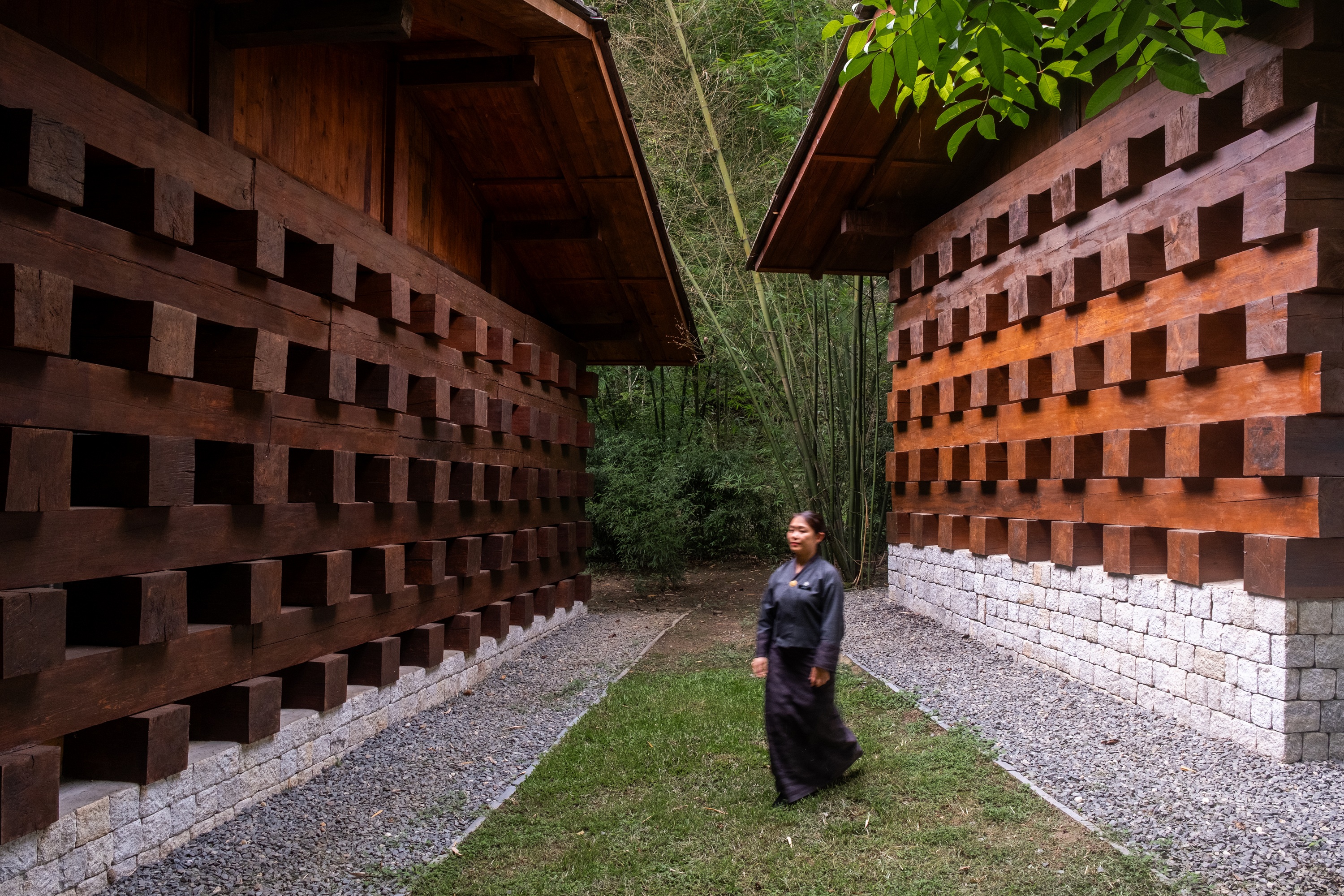 Guest on courtyard path at Pemako Punakha