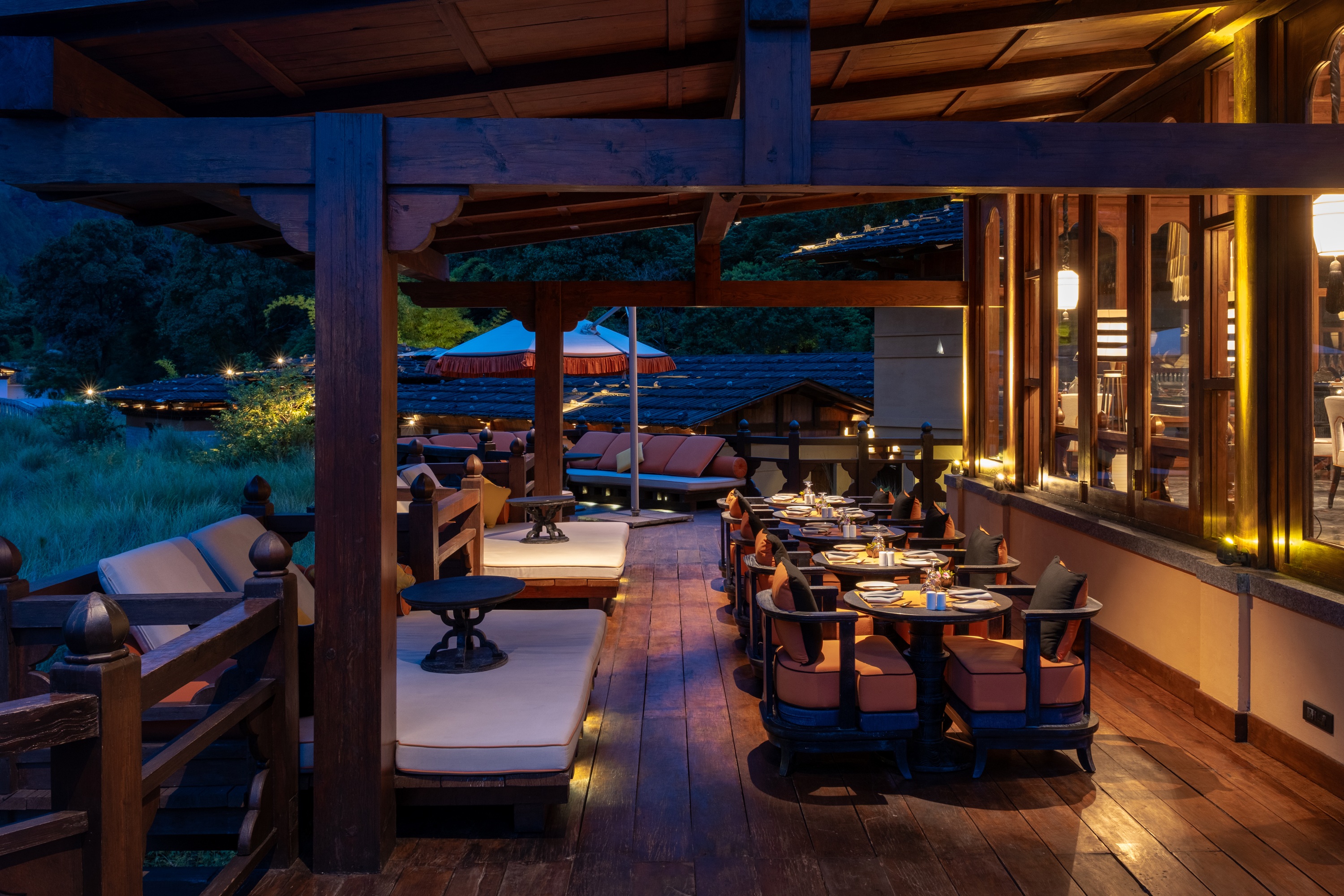 Outdoor dining terrace at night at Pemako Punakha