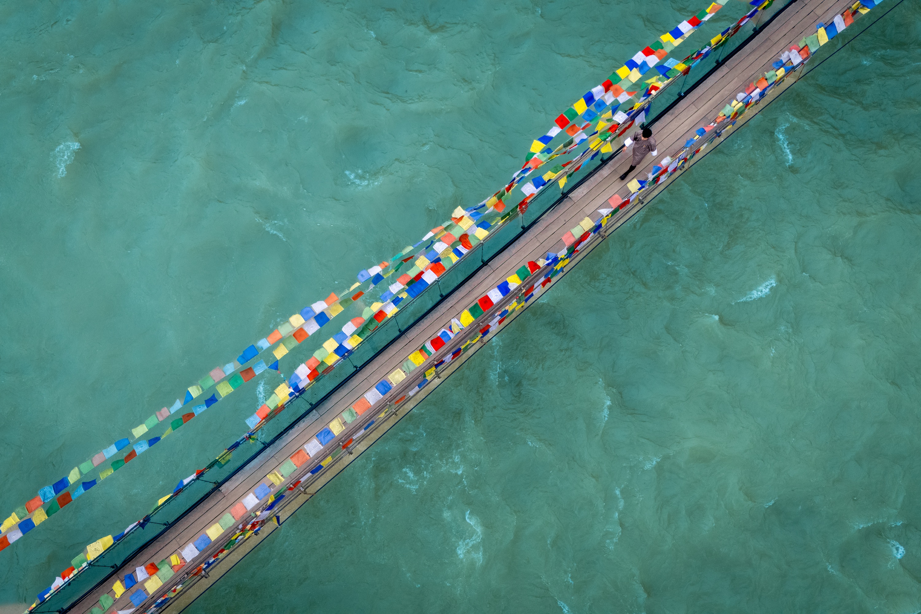 Prayer flag bridge aerial at Pemako Punakha