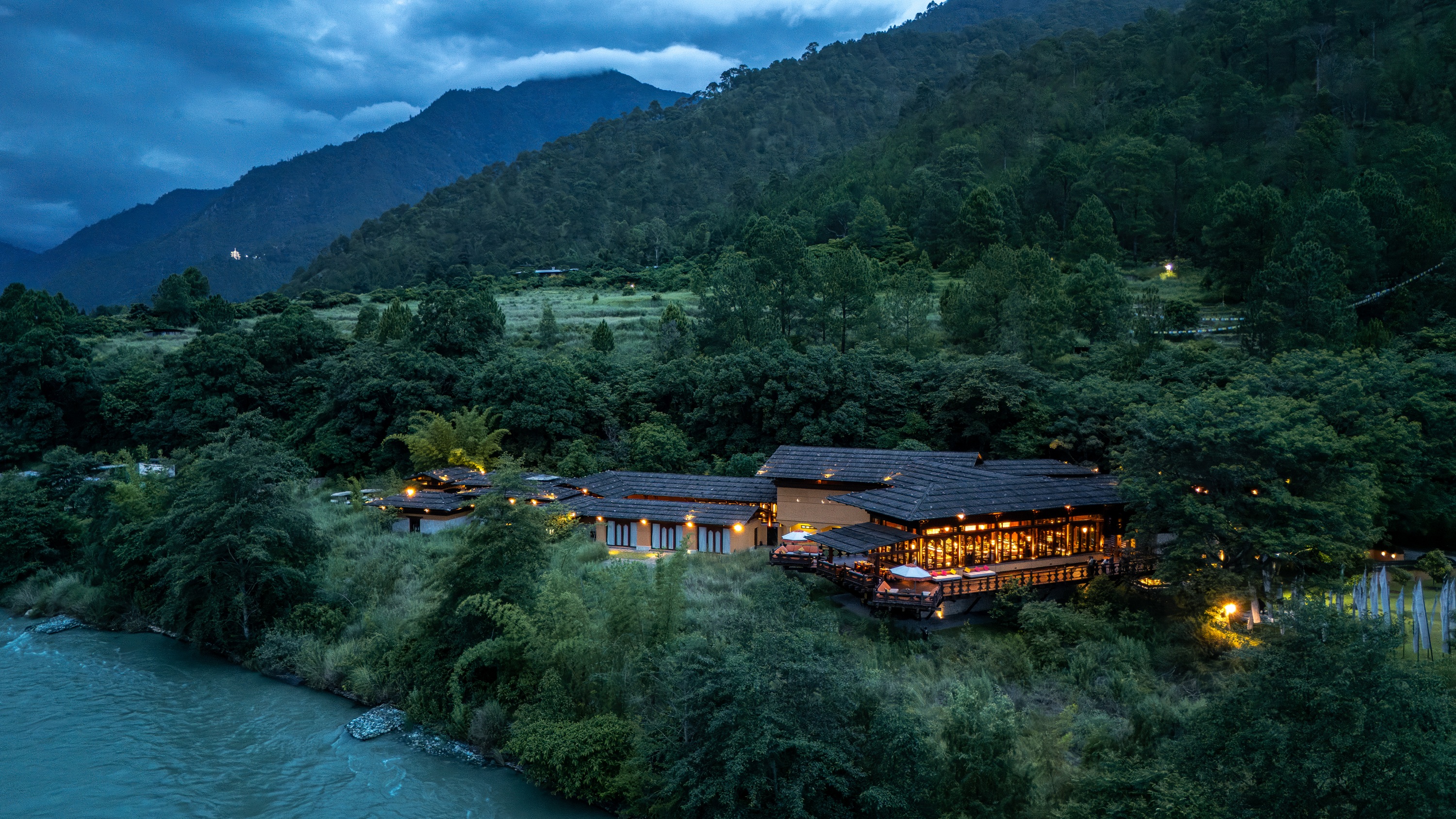 Riverside resort at dusk at Pemako Punakha