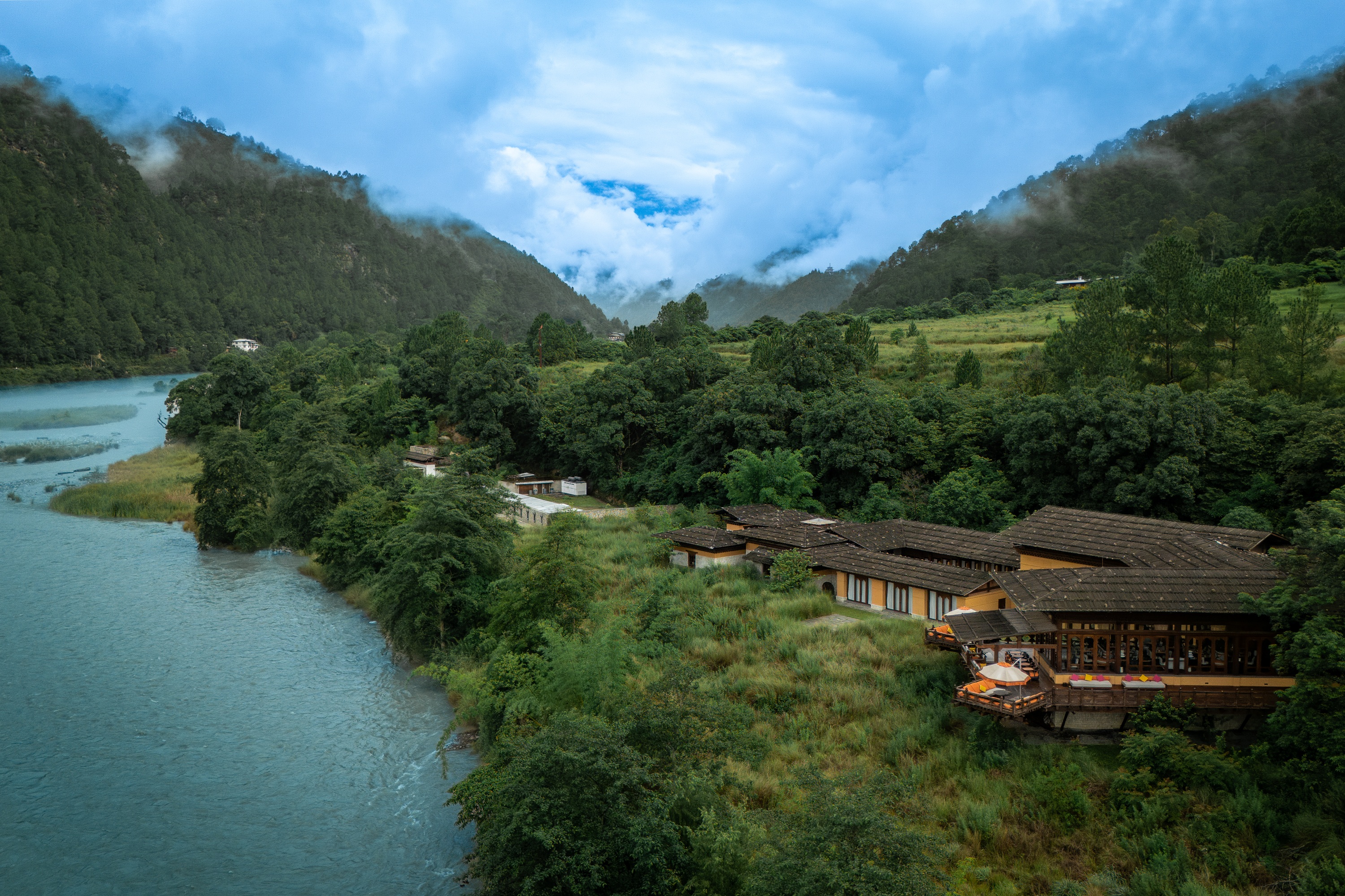 Riverside resort surrounded by mountains at Pemako Punakha